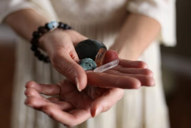 woman holding crystals in hand